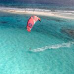 a person parasailing in the ocean on a sunny day